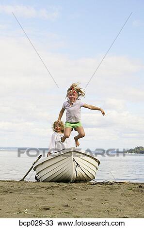Children playing in a rowboat on a beach View Large Photo Image Stock Image - Children playing in a rowboat on a beach. Fotosearch
