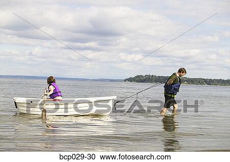 Dad and daughter using a rowboat View Large Photo Image Stock Image - Dad and daughter using a rowboat. Fotosearch