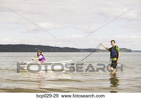 Stock Photo - Dad and daughter using a rowboat. Fotosearch