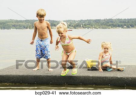 Kids playing on a raft View Large Photo Image Stock Image - Kids playing on a raft. Fotosearch