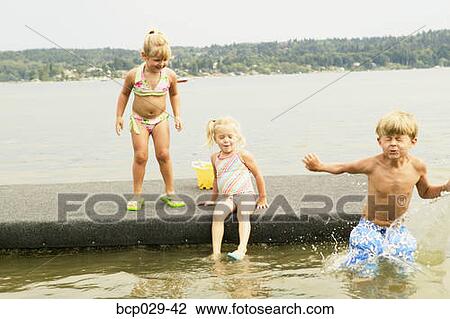 Kids playing on a raft View Large Photo Image Stock Image - Kids playing on a raft. Fotosearch