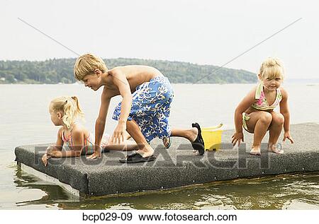 Kids playing on a raft View Large Photo Image Stock Photo - Kids playing on a raft. Fotosearch