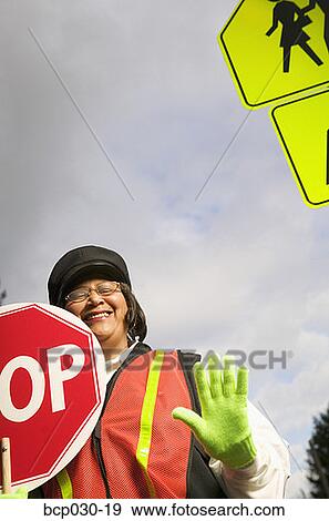 A female crossing guard at work View Large Photo Image Stock Photo - A female crossing guard at work. Fotosearch