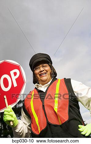 Stock Image - A female crossing guard. Fotosearch
