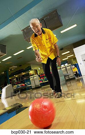 Stock Image - A senior man bowling. Fotosearch