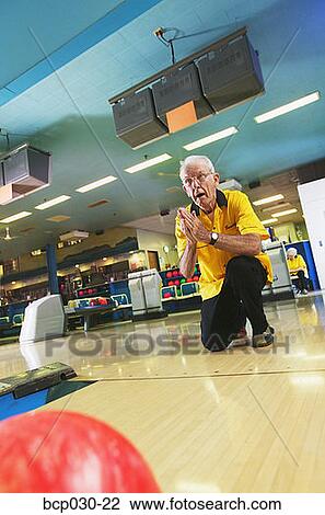 Stock Image - A senior man bowling. Fotosearch