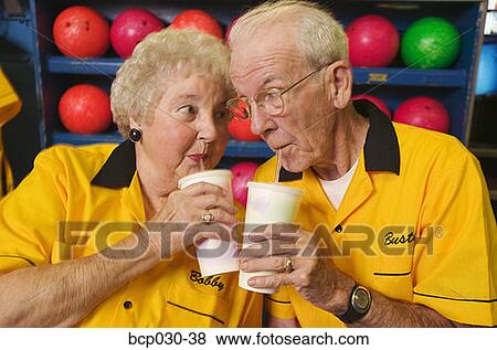 Bowling couple enjoying beverages View Large Photo Image Stock Photo - Bowling couple enjoying beverages. Fotosearch