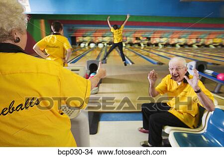 Bowling team cheering for a teammate View Large Photo Image Picture - Bowling team cheering for a teammate. Fotosearch