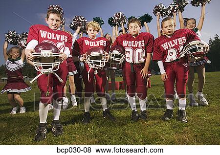 Stock Photo - Boys football team and cheerleaders. Fotosearch