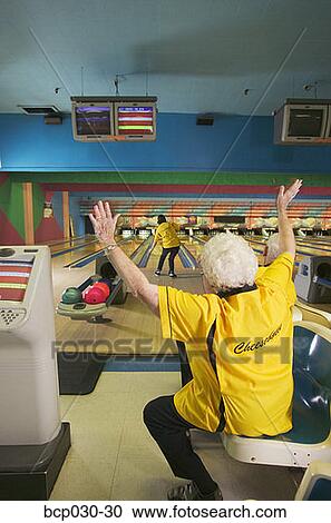 Female bowler cheering for her teammate View Large Photo Image Stock Image - Female bowler cheering for her teammate. Fotosearch