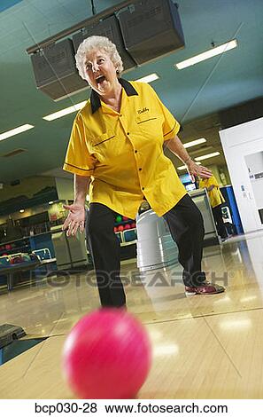 Stock Photo - Female bowler rolls a great game. Fotosearch