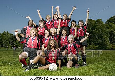 Stock Image - Female soccer team celebrating. Fotosearch