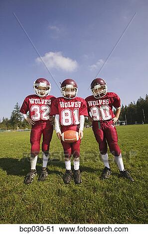 Group of three young football players View Large Photo Image Stock Image - Group of three young football players. Fotosearch