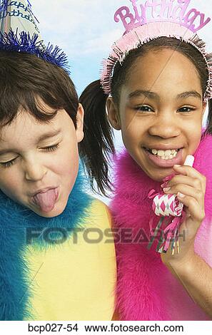 Picture - Boy and girl in party hats. Fotosearch
