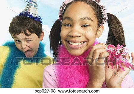 Stock Photo - Boy and girl in party hats. Fotosearch