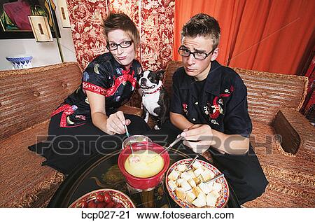 Couple at home having fondue View Large Photo Image Stock Image - Couple at home having fondue. Fotosearch