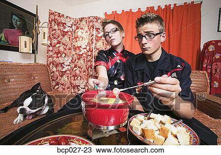 Couple at home having fondue View Large Photo Image Stock Image - Couple at home having fondue. Fotosearch