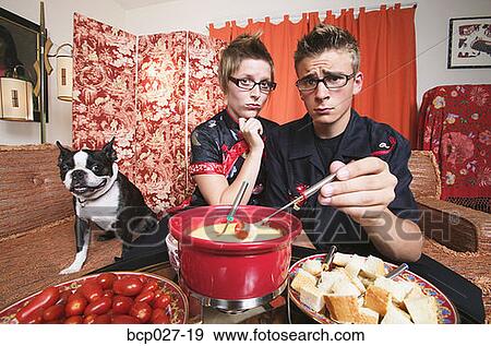 Couple at home having fondue View Large Photo Image Stock Photo - Couple at home having fondue. Fotosearch