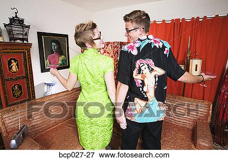 Stock Photo - Couple having cocktails at home. Fotosearch