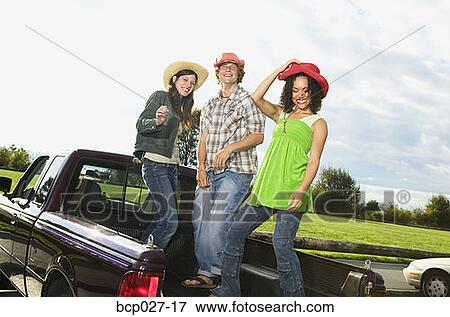 Stock Photo - People hanging out in the back of a pick up truck. Fotosearch