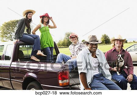 Stock Photo - People hanging out in the back of a pick up truck. Fotosearch