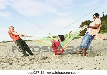 Stock Image - People having fun at a beach party. Fotosearch