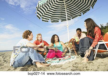 People relaxing at a beach party View Large Photo Image Picture - People relaxing at a beach party. Fotosearch