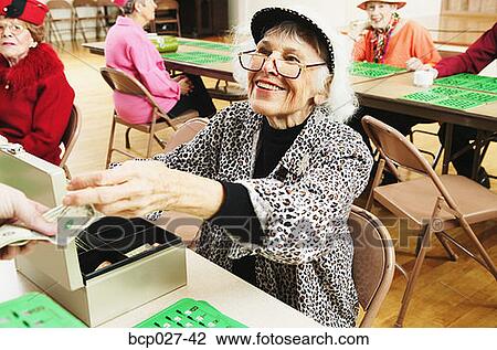 Woman taking money from bingo players View Large Photo Image Stock Image - Woman taking money from bingo players. Fotosearch