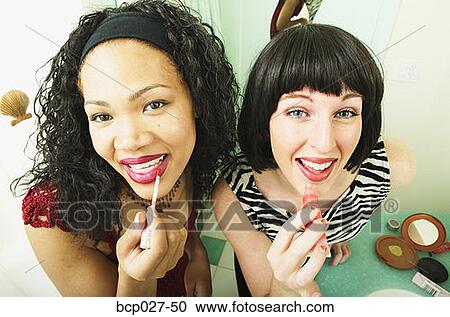 Women putting on makeup View Large Photo Image Stock Image - Women putting on makeup. Fotosearch
