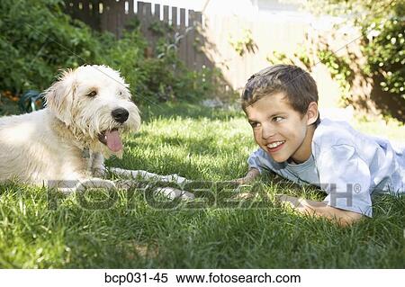 Stock Photography - Boy and dog together outdoors. Fotosearch