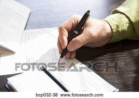 Closeup of man writing out a check View Large Photo Image Stock Photo - Closeup of man writing out a check. Fotosearch