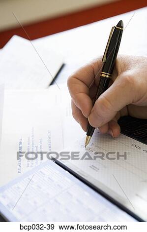 Closeup of man writing out a check View Large Photo Image Stock Photo - Closeup of man writing out a check. Fotosearch