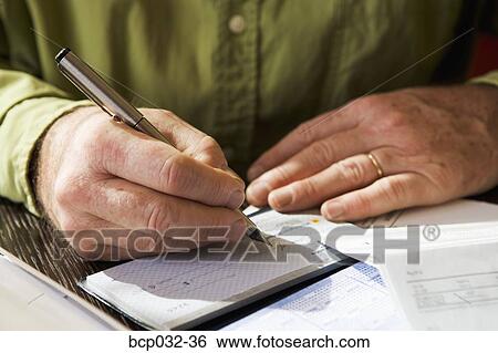Stock Photograph - Closeup of man writing out a check. Fotosearch