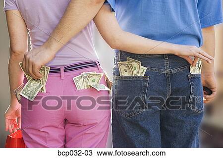 Couple sneaking money from each other View Large Photo Image Stock Image - Couple sneaking money from each other. Fotosearch