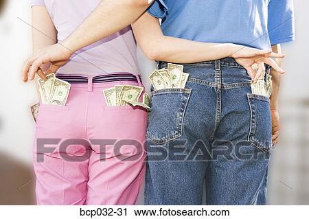 Stock Image - Couple sneaking money from each other. Fotosearch