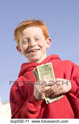 Happy boy holding American currency View Large Photo Image Stock Image - Happy boy holding American currency. Fotosearch