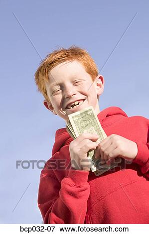 Happy boy holding American currency View Large Photo Image Stock Photo - Happy boy holding American currency. Fotosearch