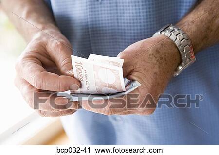 Man holding euro banknotes View Large Photo Image Stock Image - Man holding euro banknotes. Fotosearch
