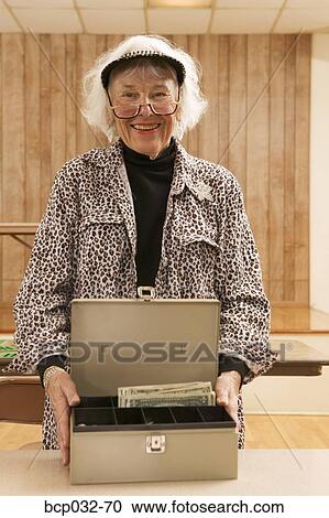 Senior woman with cash box View Large Photo Image Stock Image - Senior woman with cash box. Fotosearch
