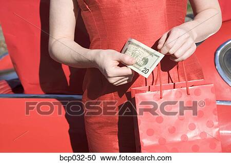 Woman holding American currency View Large Photo Image Stock Image - Woman holding American currency. Fotosearch