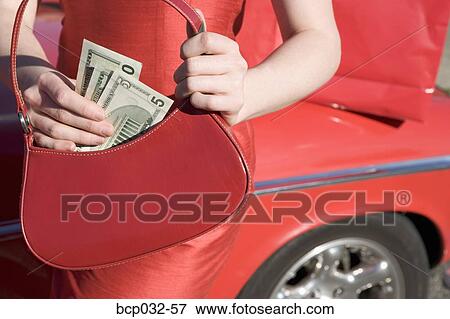 Woman holding American currency View Large Photo Image Stock Photo - Woman holding American currency. Fotosearch