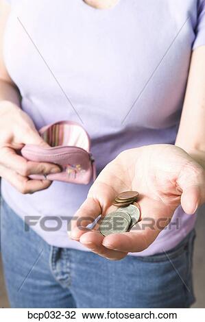 Woman holding coins and change purse View Large Photo Image Stock Image - Woman holding coins and change purse. Fotosearch
