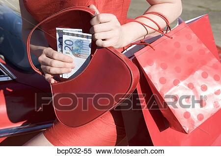 Woman holding euros and shopping bags View Large Photo Image Stock Photography - Woman holding euros and shopping bags. Fotosearch