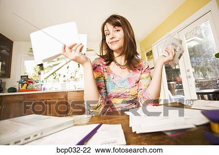 Woman looking at bills in mail View Large Photo Image Stock Image - Woman looking at bills in mail. Fotosearch