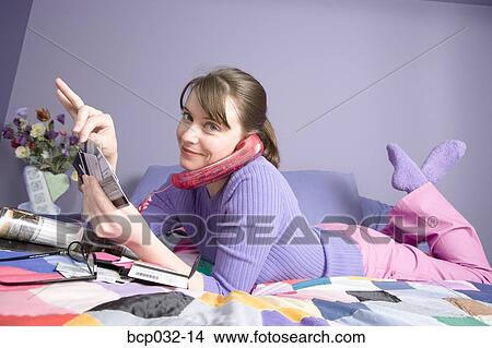 Woman on phone holding credit cards View Large Photo Image Picture - Woman on phone holding credit cards. Fotosearch