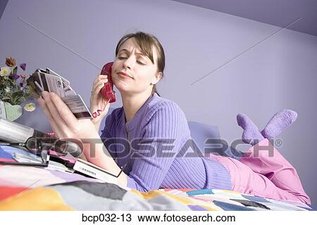 Woman on phone holding credit cards View Large Photo Image Stock Image - Woman on phone holding credit cards. Fotosearch