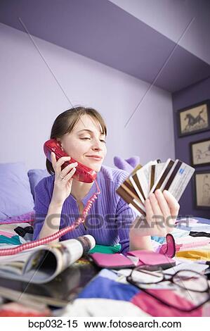 Woman on phone holding credit cards View Large Photo Image Stock Photography - Woman on phone holding credit cards. Fotosearch