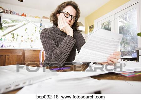 Woman reading paperwork View Large Photo Image Stock Photo - Woman reading paperwork. Fotosearch