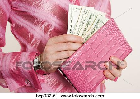 Woman removing American currency from purse View Large Photo Image Stock Image - Woman removing American currency from purse. Fotosearch