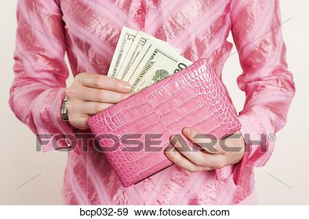 Woman removing American currency from purse View Large Photo Image Stock Photo - Woman removing American currency from purse. Fotosearch